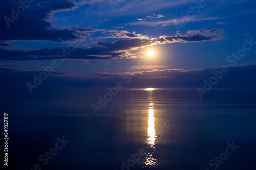 Reflection of the moon on the surface of a calm sea. Moonlight Full Moon in May 2020. Color of the year.