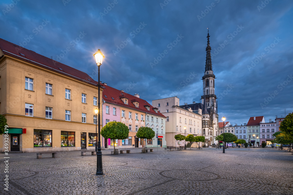 Obraz premium Zabkowice Slaskie, Poland. View of market square at dusk with old colorful houses and building of historic Town Hall