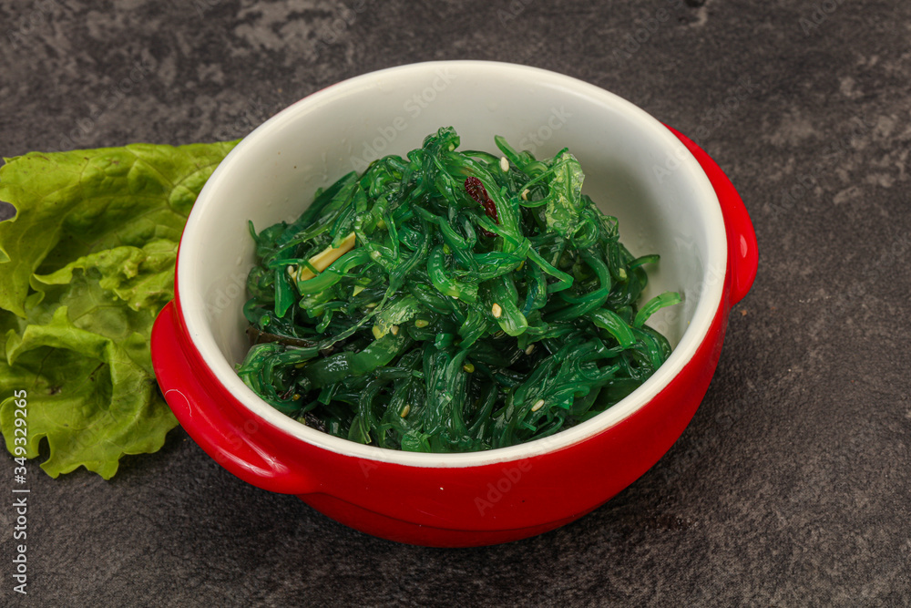 Green Chuka Seaweed Salad Isolated on White Background Top View. Wakame Sea Kelp Salat Green Chuka Seaweed Salad Isolated on White Background Top View. Wakame Sea Kelp Salat