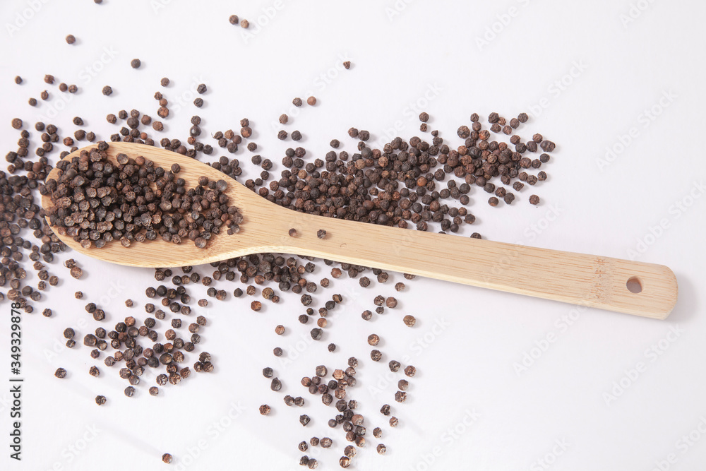 natural organic black pepper in wooden spoon natural organic black pepper in wooden spoon