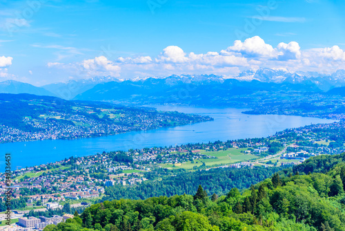 Panoramic view of Zurich lake and Alps from the top of Uetliberg mountain, from the observation platform on tower on Mt. Uetliberg, Switzerland, Europe