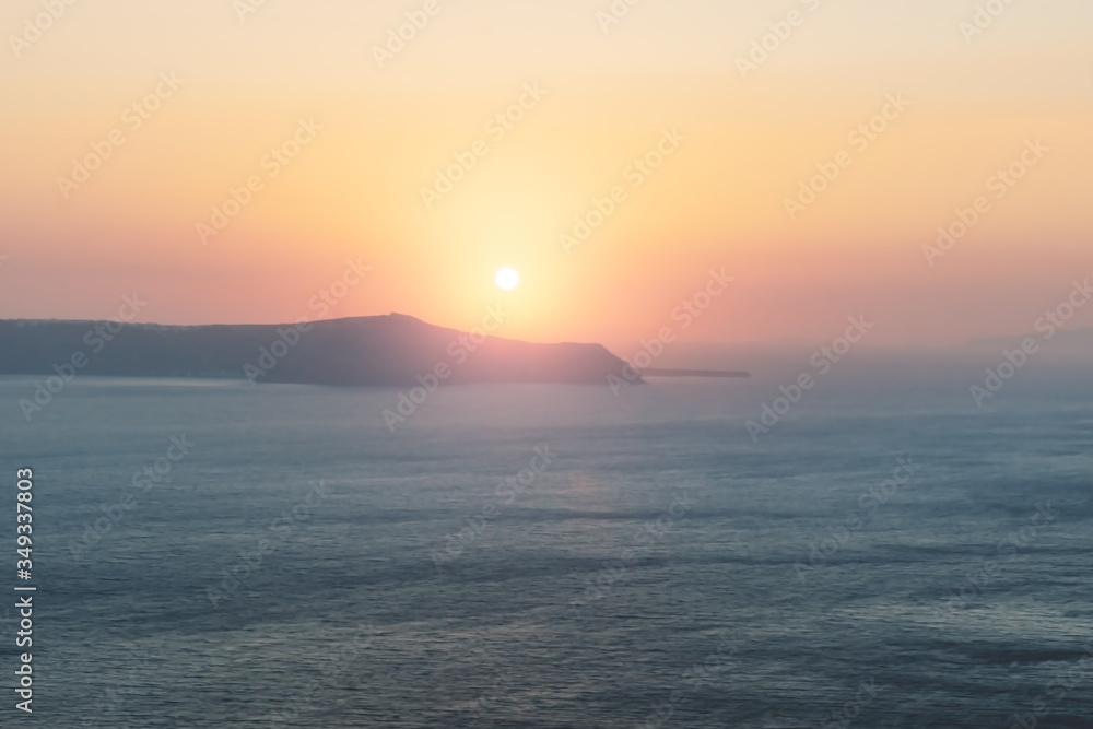 Blurred sunset abstract background along the coast of Fira, Santorini, Greece