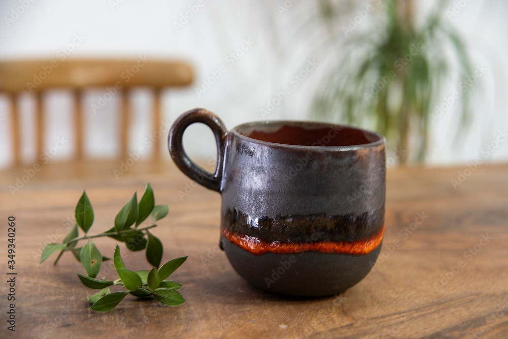 colorful handmade ceramic coffee cup on wooden table
