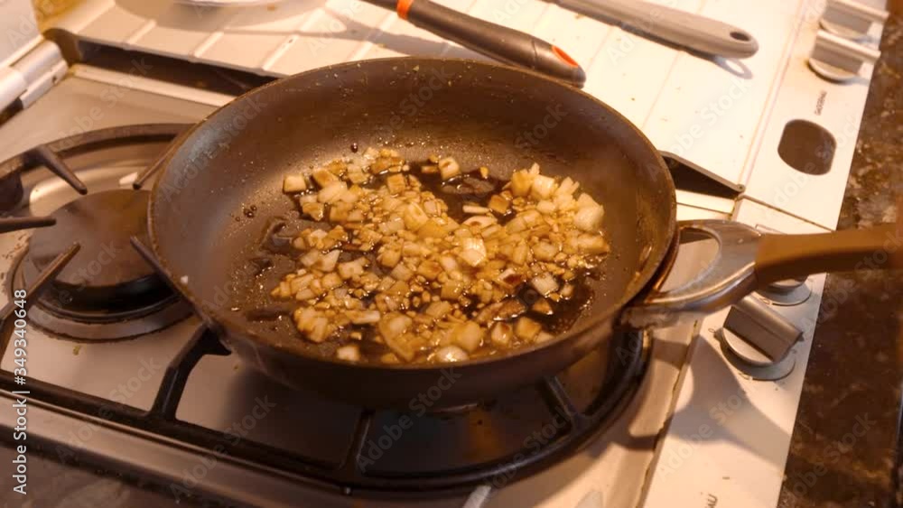Teriyaki sauce being drizzled on cooking onions Teriyaki sauce being drizzled on cooking onions