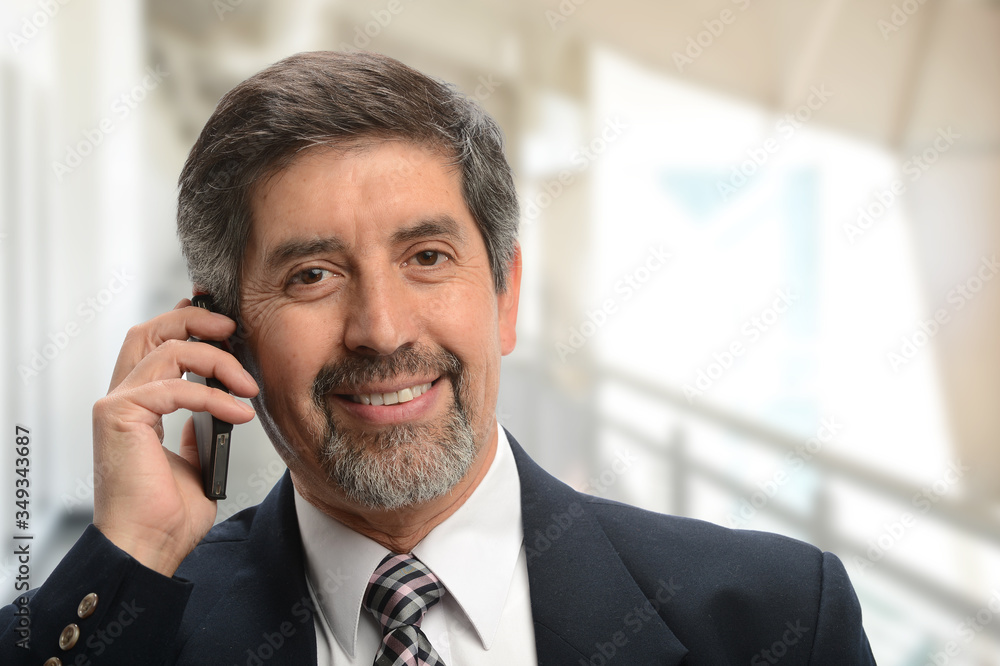 Mature hispanic businessman on the cell phone Mature hispanic businessman on the cell phone