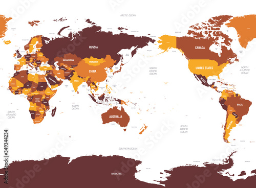 World map - Asia, Australia and Pacific Ocean centered. Brown orange hue colored on dark background. High detailed political map of World with country, ocean and sea names labeling