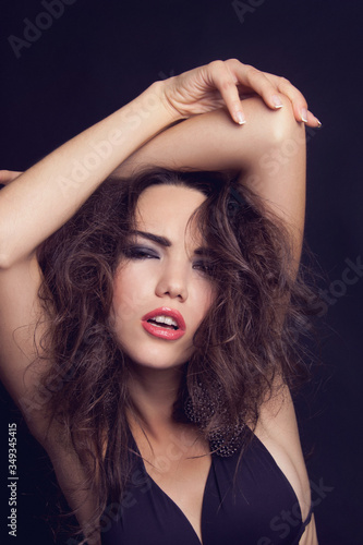Portrait of beautiful passion young european brunette girl with fashion makeup on black background