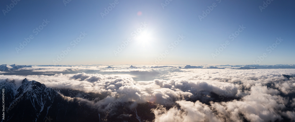 Aerial Panoramic View of Remote Canadian Mountain Landscape during sunny morning. Located near Vancouver, British Columbia, Canada. Nature Panorama Background. Authentic Aerial Panoramic View of Remote Canadian Mountain Landscape during sunny morning. Located near Vancouver, British Columbia, Canada. Nature Panorama Background. Authentic