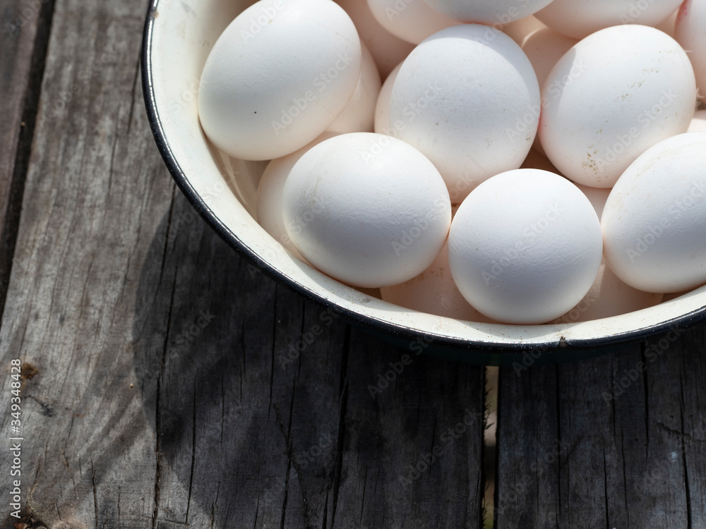 Fresh organic chicken eggs in a metal enamel bowl Fresh organic chicken eggs in a metal enamel bowl
