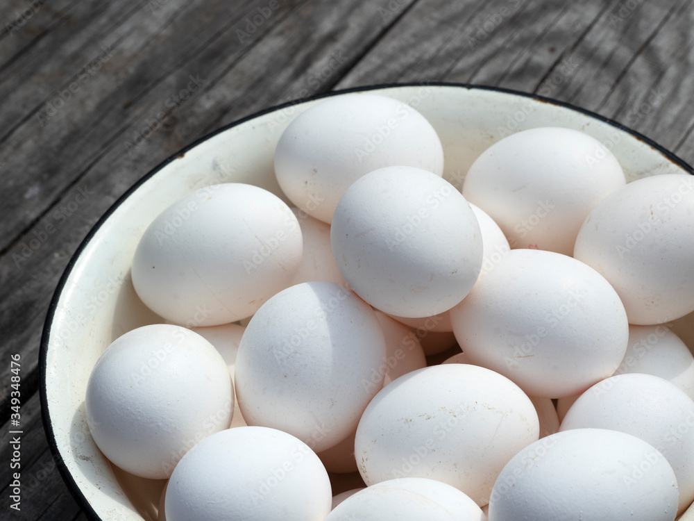 Fresh organic chicken eggs in a metal enamel bowl Fresh organic chicken eggs in a metal enamel bowl