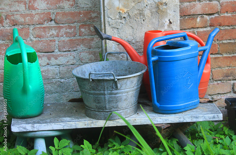 buckets and watering cans in the garden buckets and watering cans in the garden