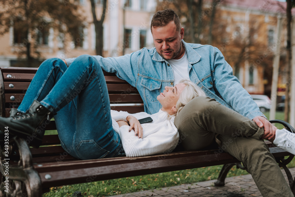 Youth in love enjoying their date, using smartphone Youth in love enjoying their date, using smartphone