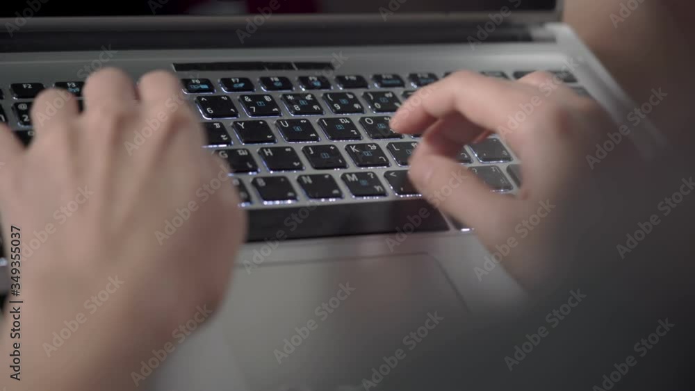 Over shoulder keyboard typing hands, writing project working from home during quarantine, covid-19 virus, Writing Email, paper work progression, financial business busy multitasking routine Over shoulder keyboard typing hands, writing project working from home during quarantine, covid-19 virus, Writing Email, paper work progression, financial business busy multitasking routine
