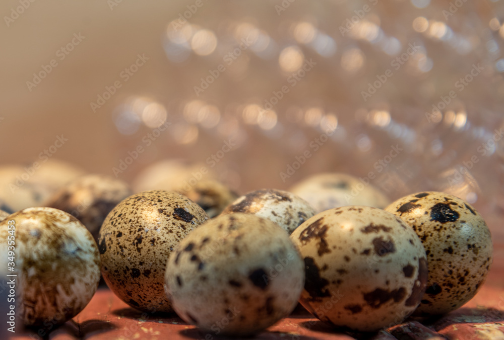 Quail eggs on red wooden surface on blurred background Quail eggs on red wooden surface on blurred background