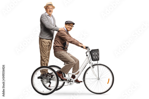 Elderly men riding on a tricycle