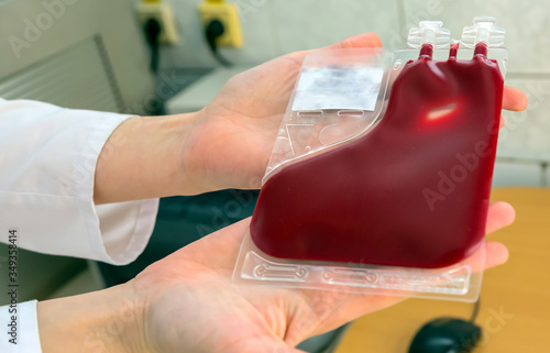 Placental cord blood bank donated blood unit prepared by gloved hands isolated. photo