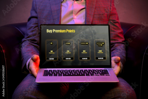 Micropayment system on the display of a modern laptop that is holds by an elegant man. Graphic made in graphic programme photo
