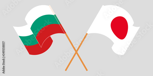Crossed and waving flags of Bulgaria and Japan