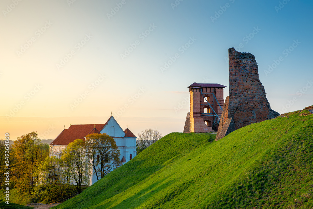 Ruins of the old castle at sunrise. Old castle in the rays of the morning sun.