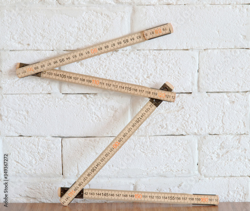 Принти на полотні wooden folding ruler on brick wall background
