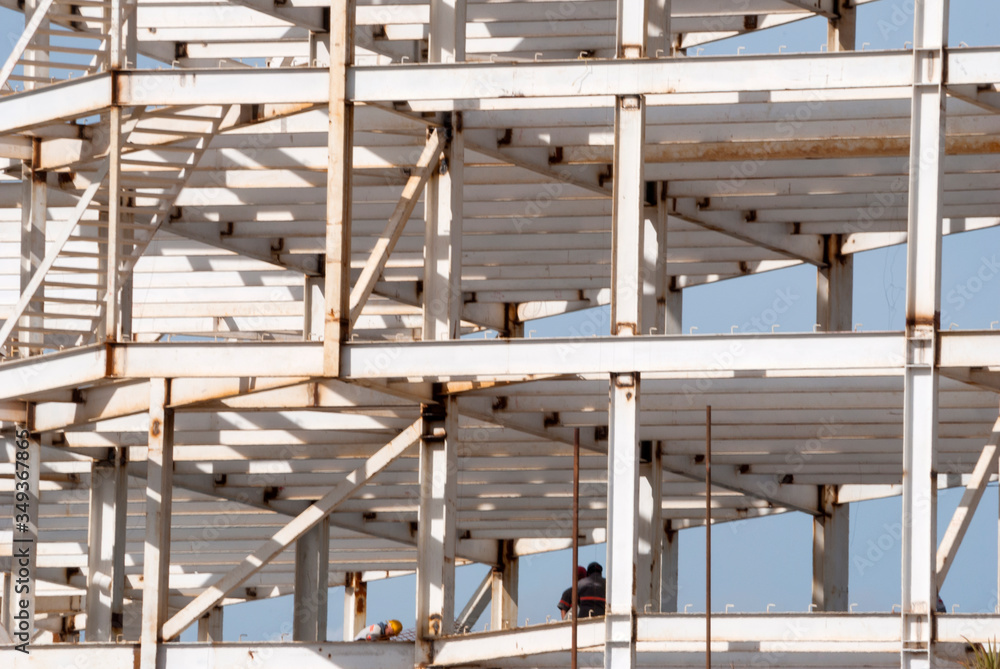 Construction of a steel-based building in Guatemala City at sunrise. spaces for housing and office in commercial area. Construction of a steel-based building in Guatemala City at sunrise. spaces for housing and office in commercial area.
