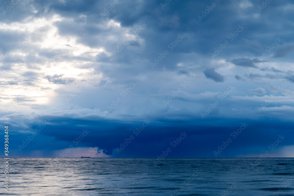 Heavy rainfall over ocean during sunset