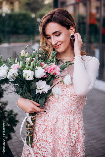 Girl with a bouquet of flowers outdoors photo