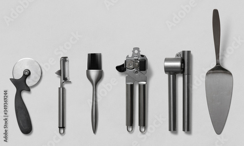 Pizza cutter, potato peeler, brush, can opener, garlic press, potato peeler on a white background