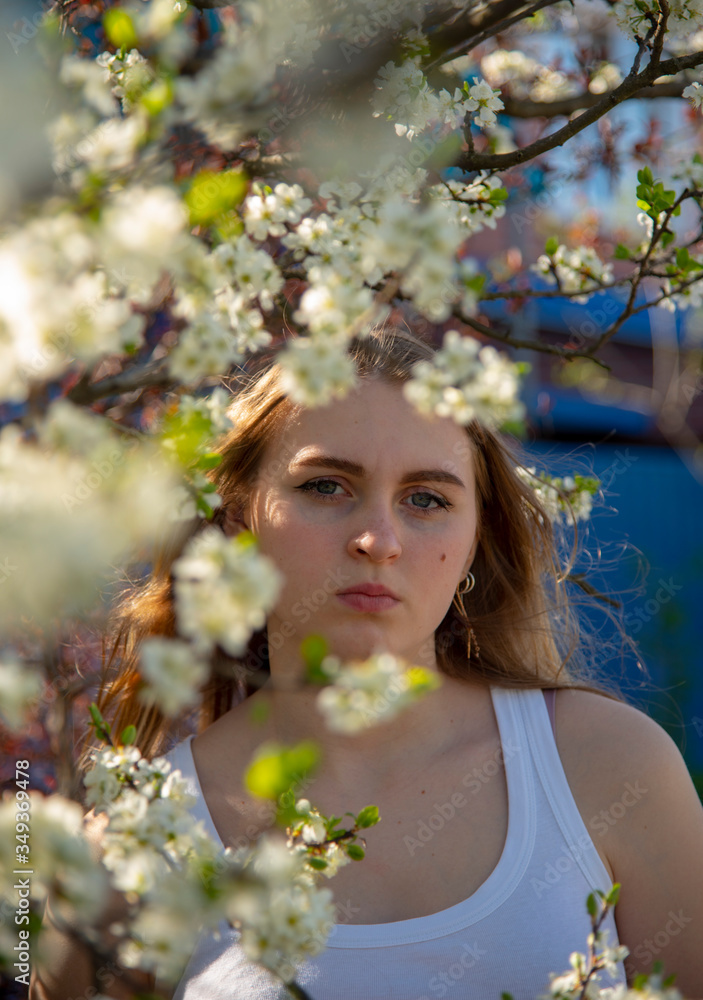 Spring Portrait of a 14-year-old girl in the branches of a flowering tree. Spring Portrait of a 14-year-old girl in the branches of a flowering tree.