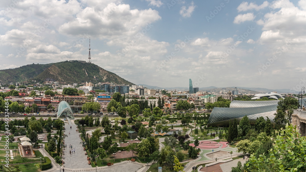 Obraz premium The view to Rhike Park in capital city of Georgia, Tbilisi. Contrast of the modern and ancient part of the city.