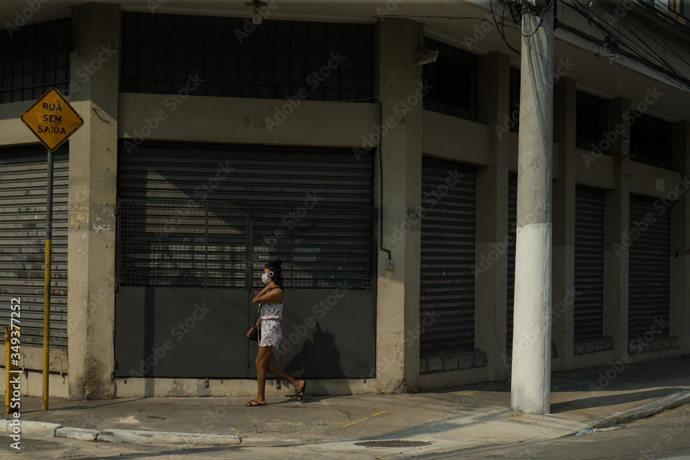 Woman walks wearing face mask to protect herself from the virus in the pandemic.