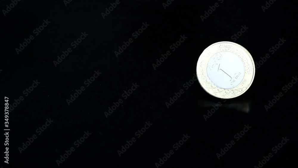 Saudi Riyal Coin Spinning on black reflector background in slow motion. Saudi Arabia Currency. Saudi Riyal Coin Spinning on black reflector background in slow motion. Saudi Arabia Currency.