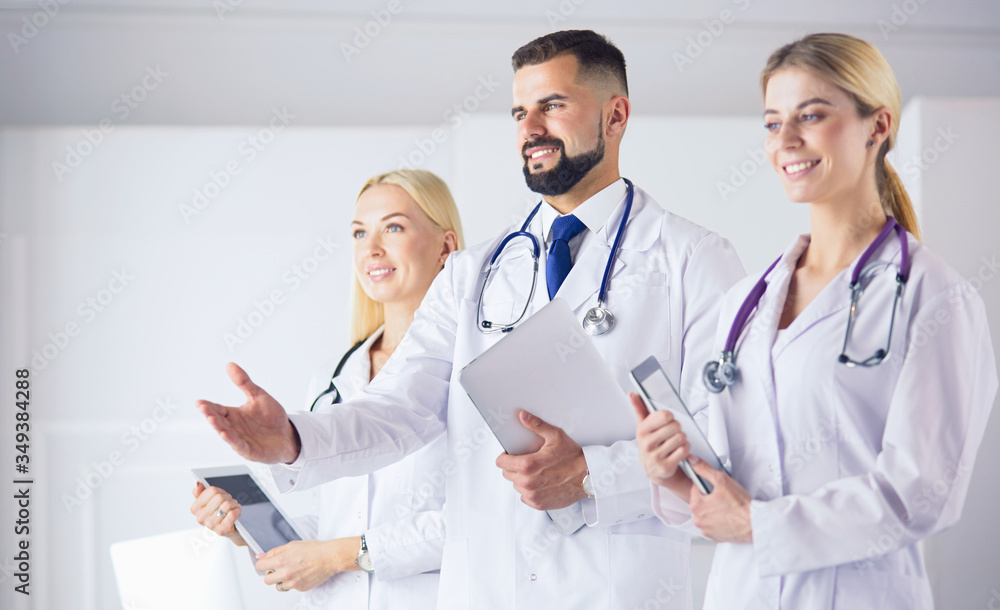 Male doctor offering handshake In Front Of His Colleagues Male doctor offering handshake In Front Of His Colleagues
