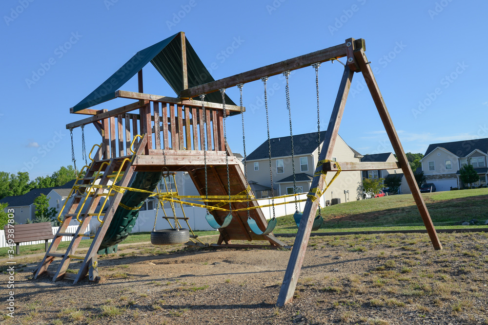 Closed children's playground from Covid-19 - caution tape Closed children's playground from Covid-19 - caution tape