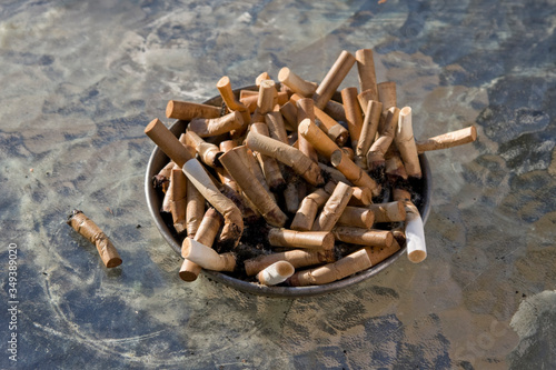 smoked cigarettes buds in ash tray 