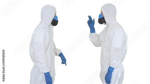 Doctors or scientists in hazamat suits meet and shake hands on white background. photo