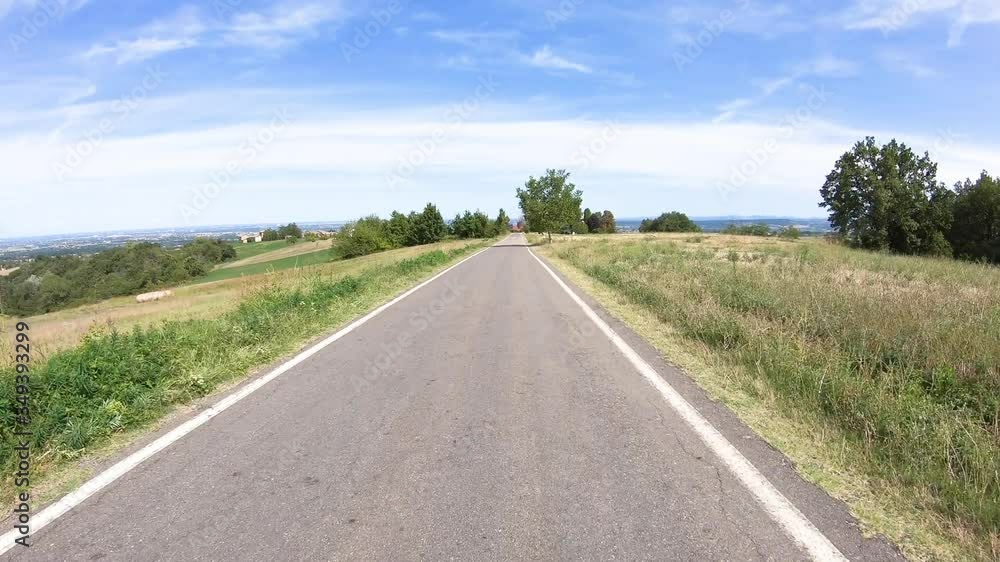 secondary paved road through green rural fields next to Costamezzana (Noceto), Province of Parma, Emilia-Romagna, Italy secondary paved road through green rural fields next to Costamezzana (Noceto), Province of Parma, Emilia-Romagna, Italy