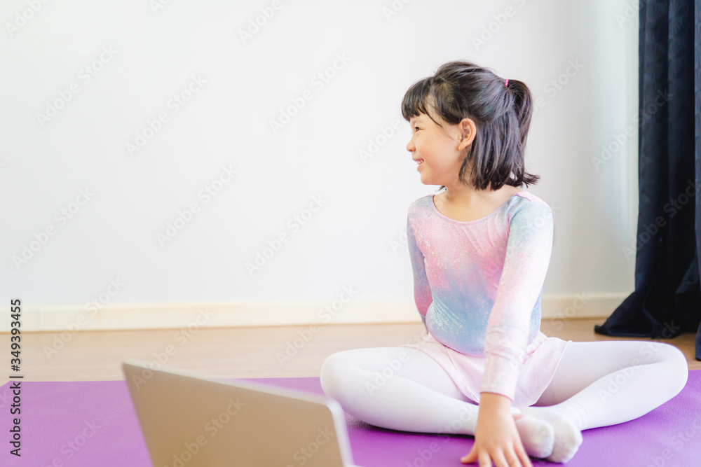 Video streaming Stay fit at home.home fitness workout class live streaming online.Asian kid girl in yoga gymnastics keep calm and fit.Online class live videos on laptop at home.New normal healthcare. Video streaming Stay fit at home.home fitness workout class live streaming online.Asian kid girl in yoga gymnastics keep calm and fit.Online class live videos on laptop at home.New normal healthcare.