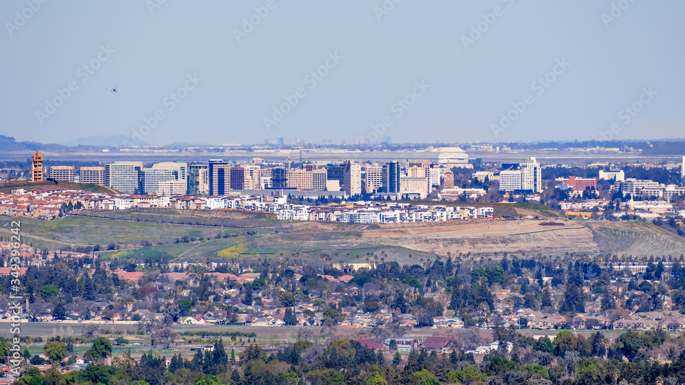 Aerial view of the San Jose downtown skyline on a clear day; residential neighborhoods visible in the foreground; south San Francisco bay, California