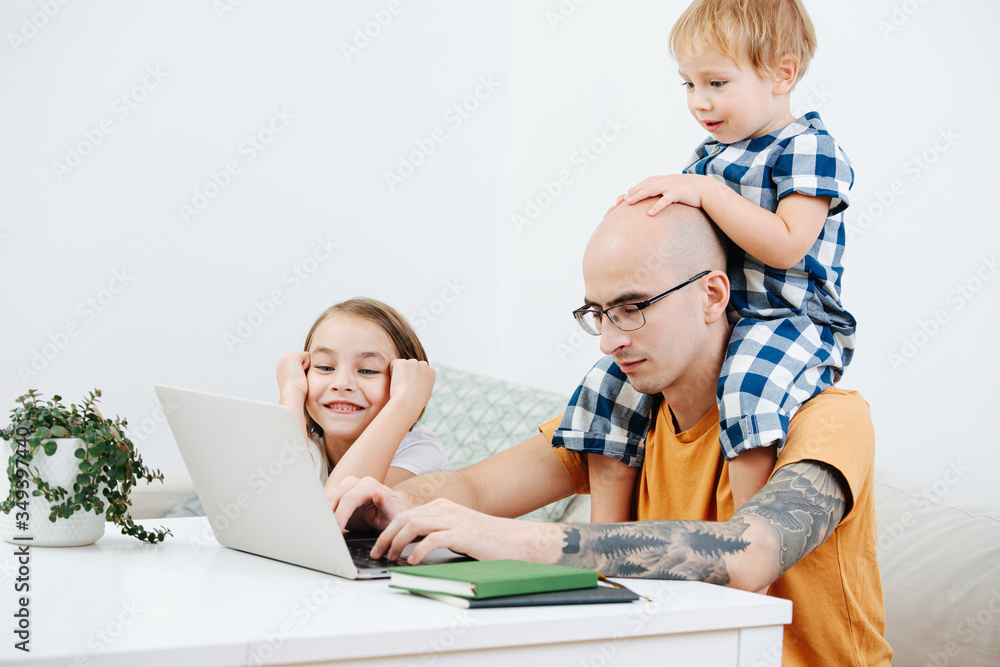 Sleepy dad working home during isolation, his kids make him their entertainment Sleepy dad working home during isolation, his kids make him their entertainment