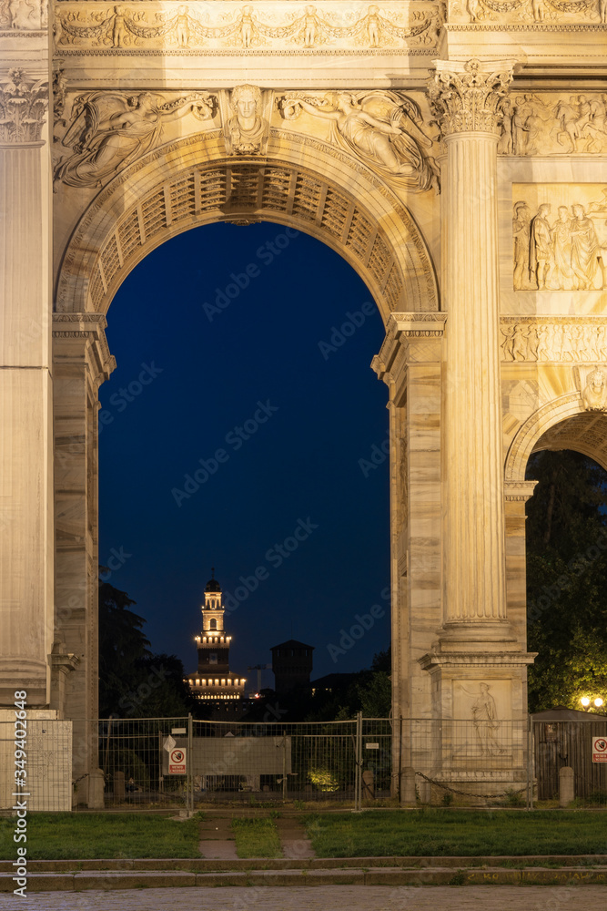 Sforza Castle night view through Arco della Pace, Arch of Peace in Piazza Sempione. One of the symbols of Milan and one of the most important neoclassical monuments in the city.