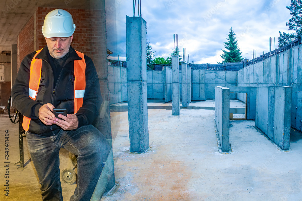 Work on creating the Foundation of the future house. Construction of houses on individual projects. Builder with a phone on the background of the Foundation of a new building. House under the key. Work on creating the Foundation of the future house. Construction of houses on individual projects. Builder with a phone on the background of the Foundation of a new building. House under the key.