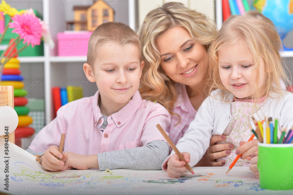 Portrait of mother with cute children drawing with pencils at home Portrait of mother with cute children drawing with pencils at home
