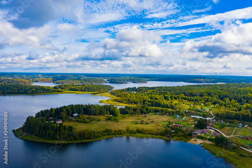 Panorama of Karelia on a Sunny day. View of Karelia from a height. Nature of Russia. Leningrad region. Houses on the Vuoksa river. Lake Ladoga. Islands in lake Ladoga. Summer trip to Russia.