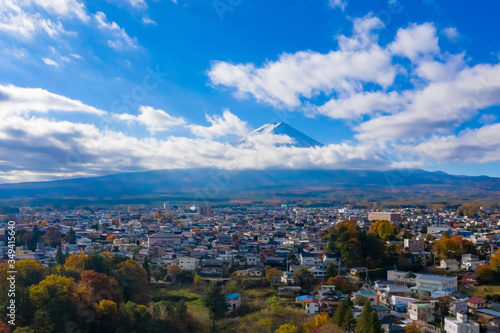 Japan. Fujikawaguchiko town at the foot of Mount Fuji. A small town next to the volcano of Fujiyama. Japanese village on the background of the volcano fuji. Clouds on the background of Fujiyama.