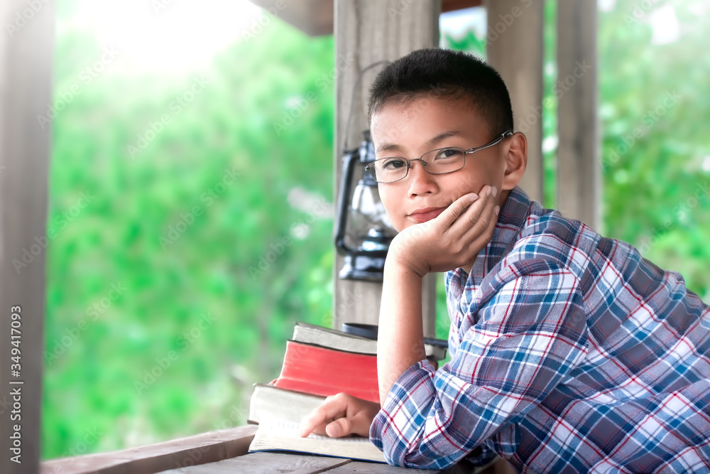 Fototapeta premium Happy boy reading the Bible on wooden table, Christian concept.