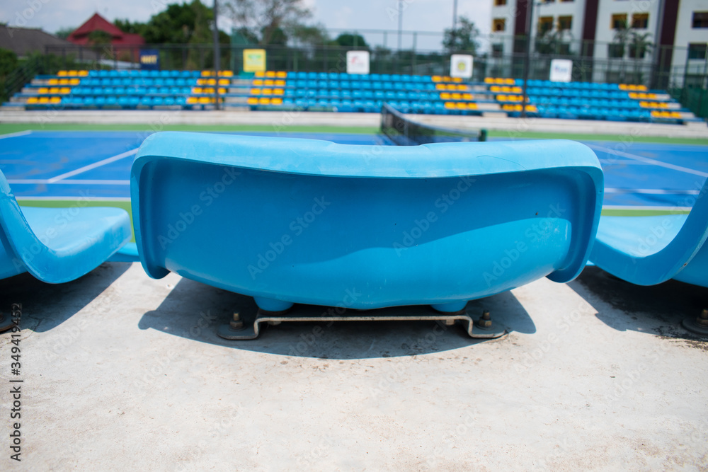 Fototapeta premium empty blue plastic seats in a stadium summer mid day