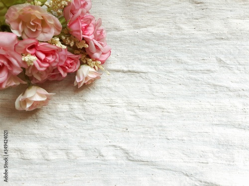 pink roses on old fabric background