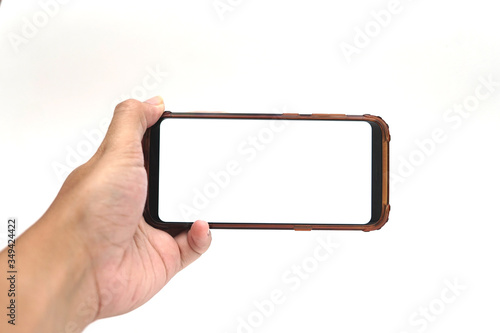 Hand with blank smart phone on landscape mode for mock up