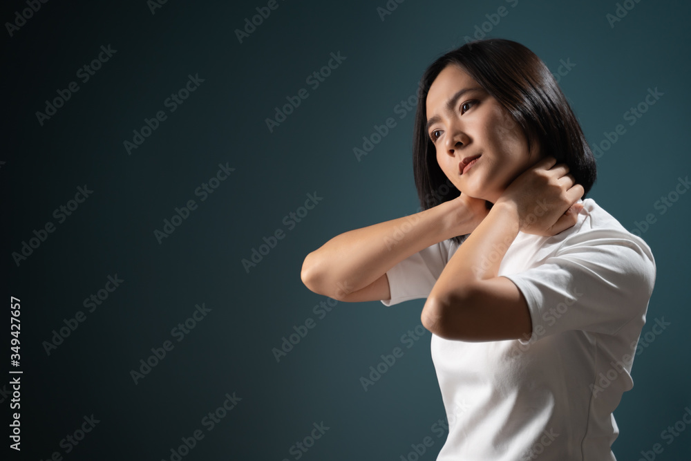 Fototapeta premium Asian woman was sick with body pain office syndrome and standing isolated over blue background. Health care concepts.